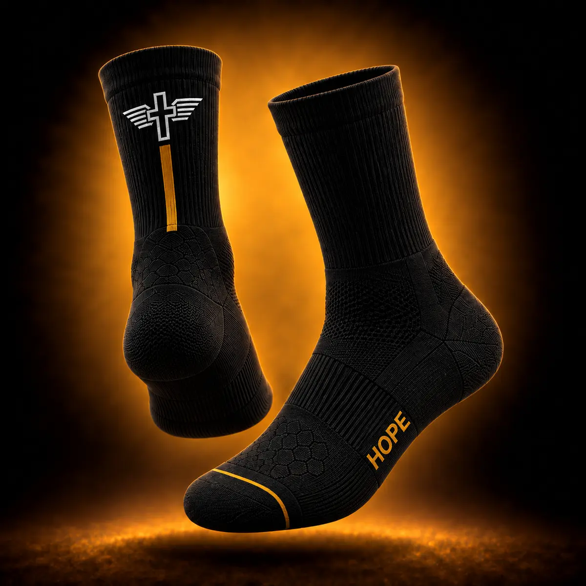 Pair of black Foundation Performance Socks showing the Achilles crest, Hope Gold stripe, and outer-side HOPE wordmark.